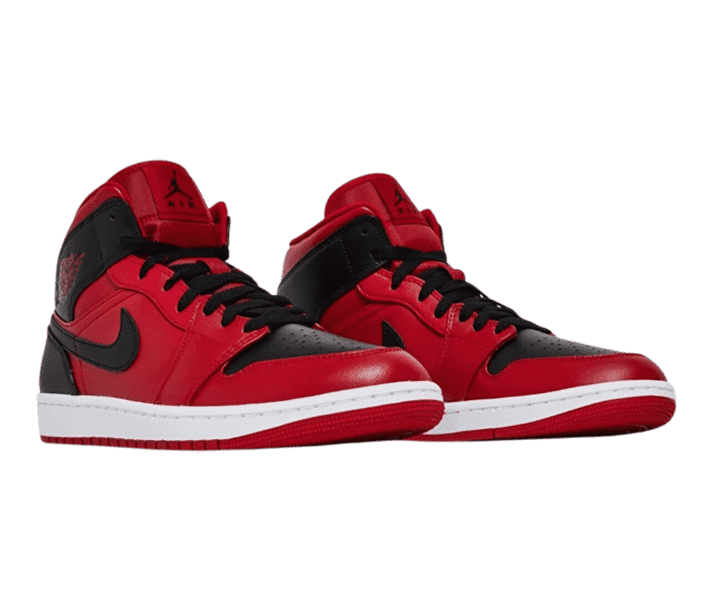 A deep red pair of AJ1 Mid sneakers with black toeboxes, heels, laces, collar straps, and Swooshes.