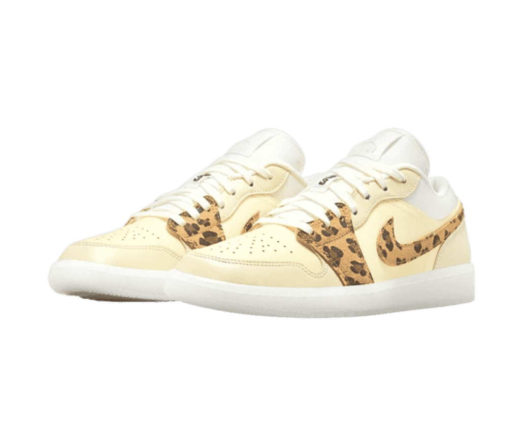 A cream pair of AJ1 Low sneakers with leopard print Swooshes and overlays.