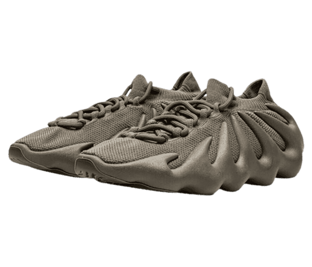 A dark tan pair of Yeezy 450 “Cinder” sneakers that have rubber soles with a wavy design reaching the collar of the shoe.