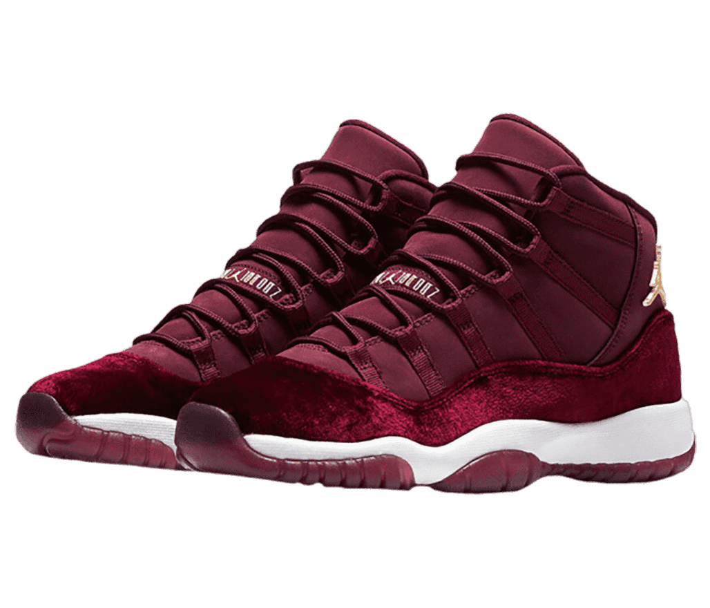 A pair of AJ11 sneakers in maroon uppers and matching suede mudguards.