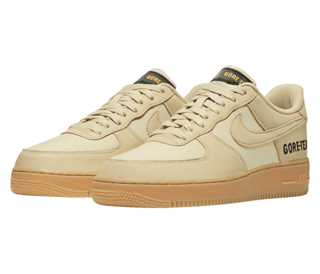 A two-tone beige pair of Gore-Tex x AF1 Low sneakers with gum soles and “GORE-TEX” printed on the sides in black.