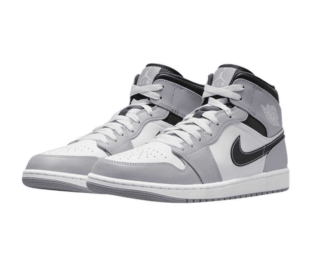 A pair of AJ1 Mid sneakers in gray and white with black Swooshes and collars.