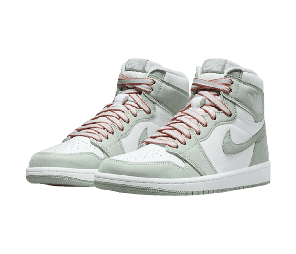 A pair of AJ1 High sneakers in white uppers with mint suede overlays and gray laces with orange outlines.