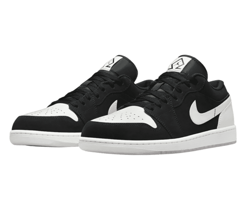 A pair of AJ1 Low “Diamond” sneakers in black with white toeboxes, soles, heels, and Swooshes.