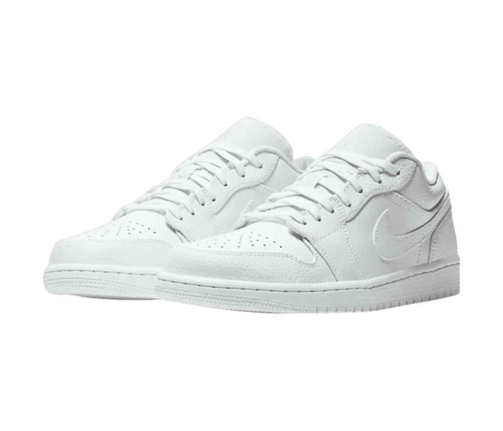 An all-white pair of AJ1 Low sneakers with tumbled leather overlays.