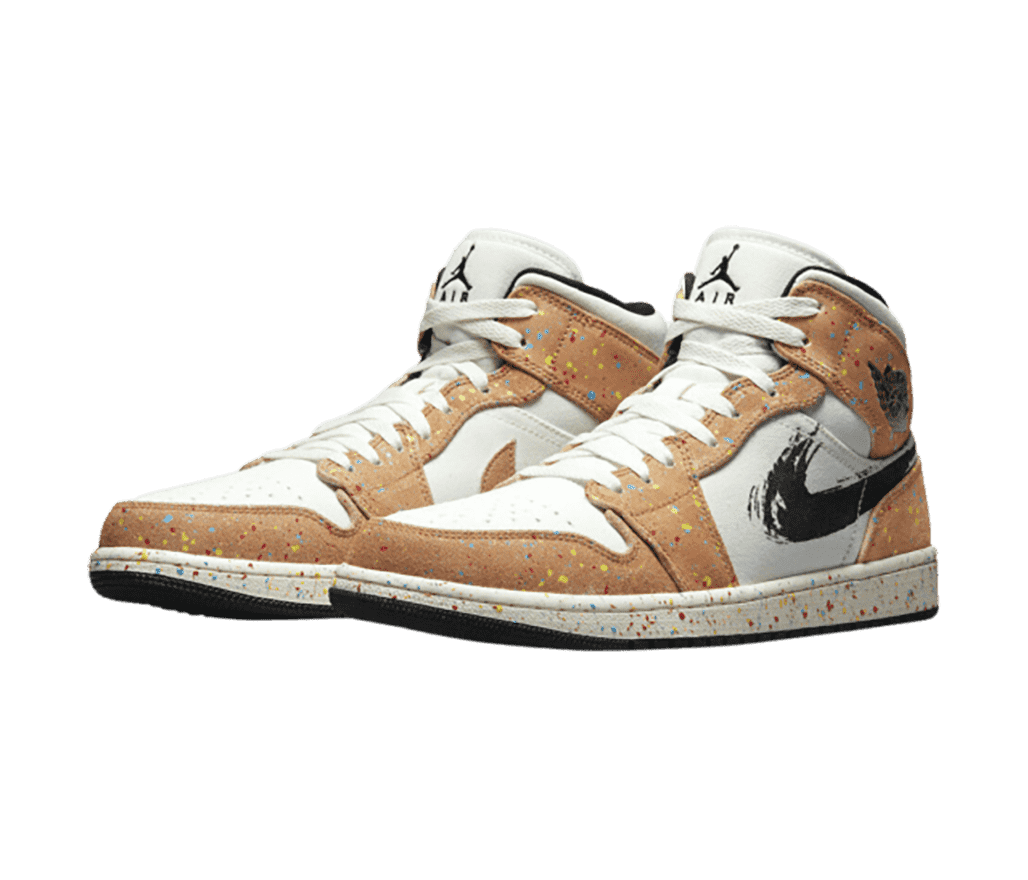 A pair of AJ1 Mid “Brushstroke” sneakers with light brown overlays, multicolored speckles, and brushstroked Swooshes.