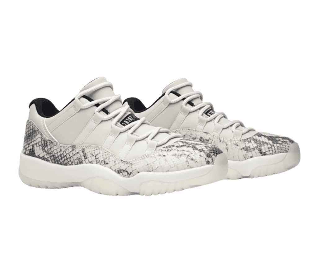 An off-white pair of AJ11 sneakers with gray and white snakeskin mudguards.