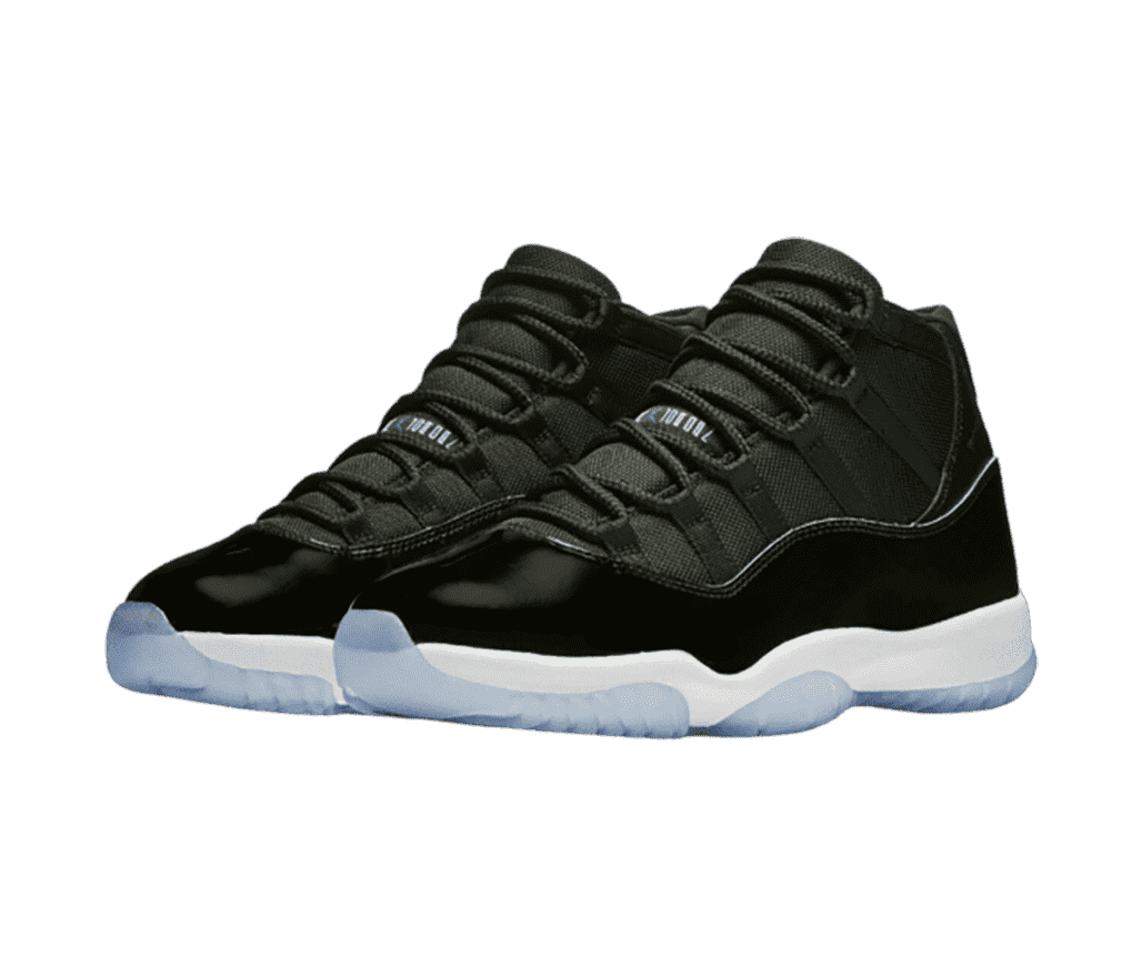 A black pair of AJ11 sneakers with patent leather mudguards and light blue translucent outsoles.