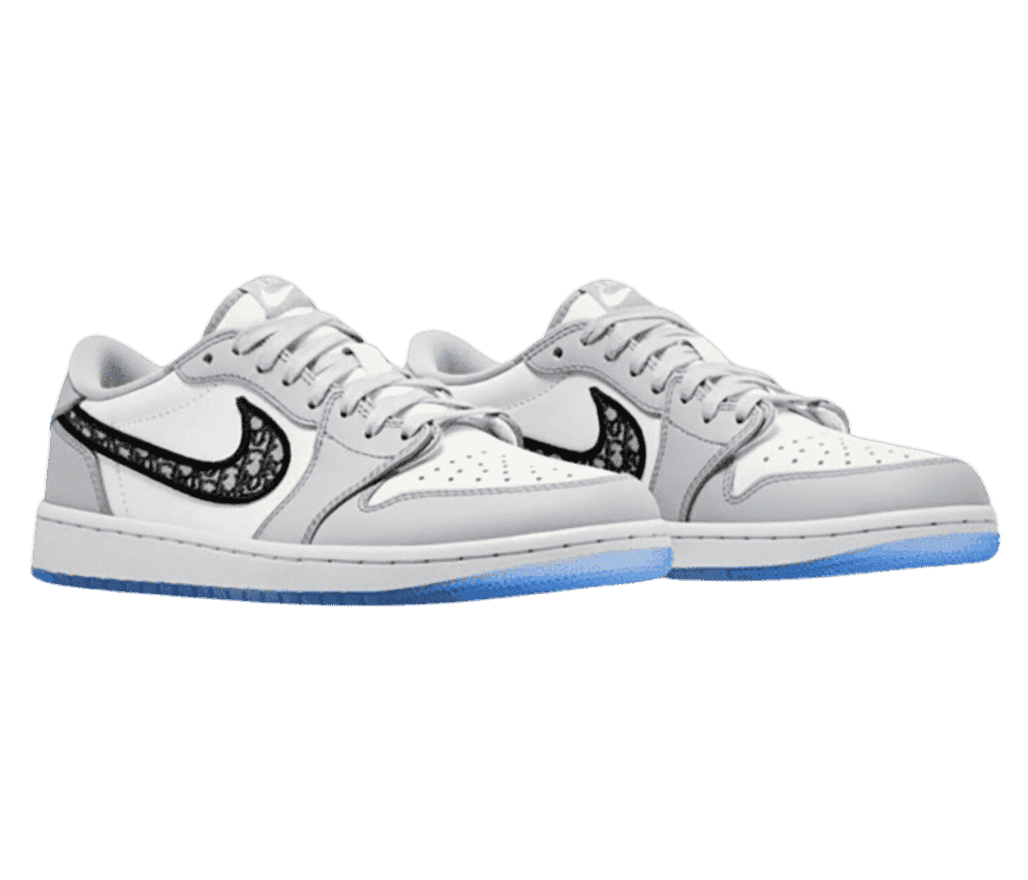 A white and gray pair of Dior x AJ1 Low sneakers with embroidered Dior markings on the Swooshes and blue outsoles.