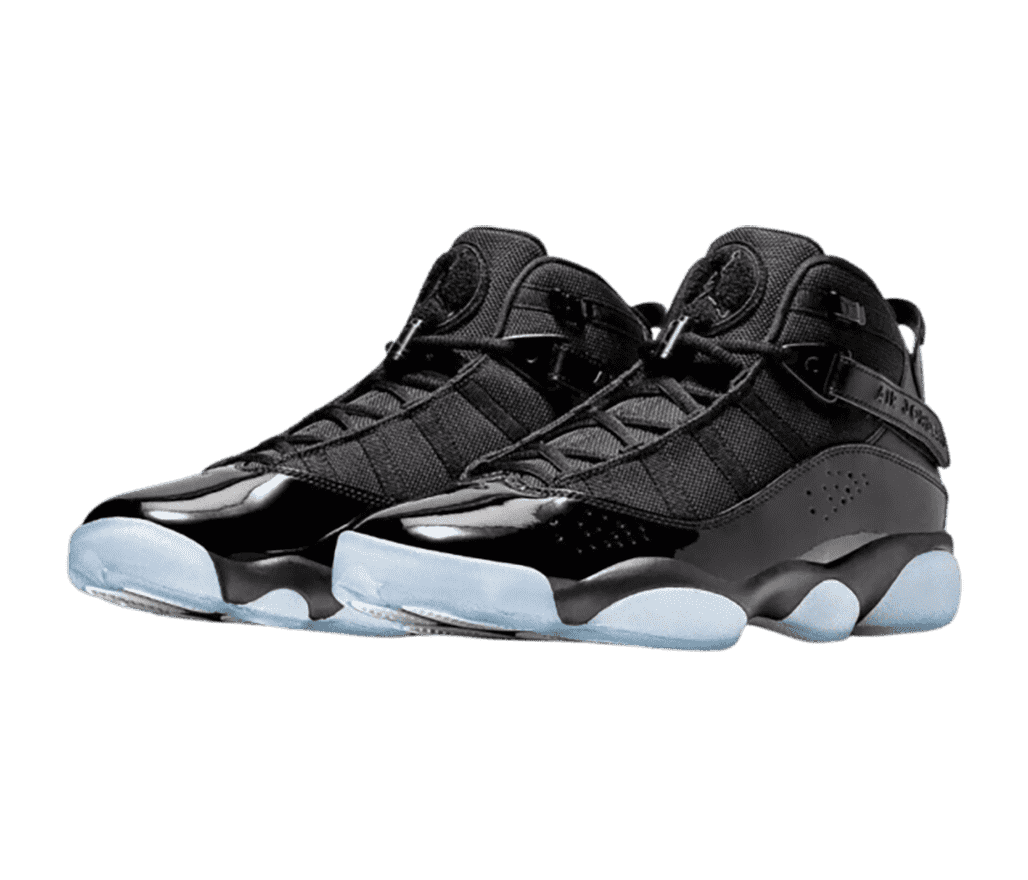 A black pair of Jordan 6 Rings sneakers with patent leather mudguards and light blue translucent outsoles.