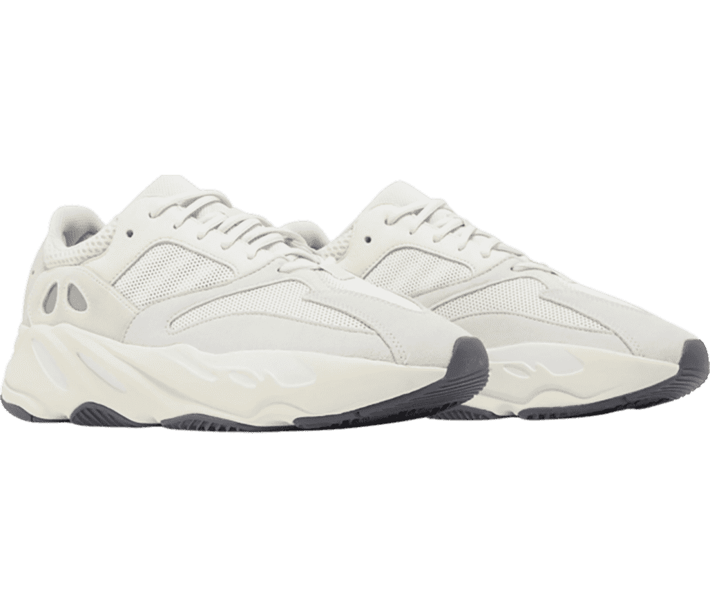 A white pair of Adidas Yeezy 700 “Analog” sneakers in suede and mesh uppers and off-white soles with white detailed sections.