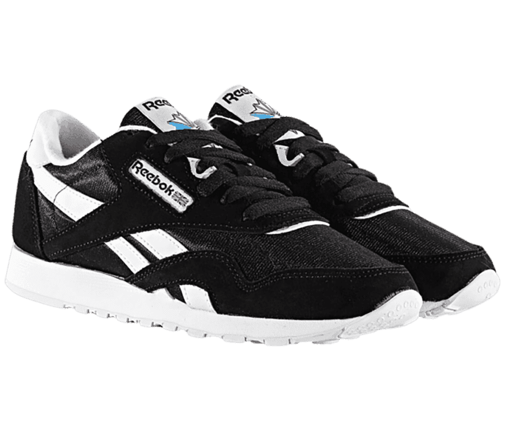A pair of women's Reebok shoes with a classic black color, white logo, soles, and counter lining. 