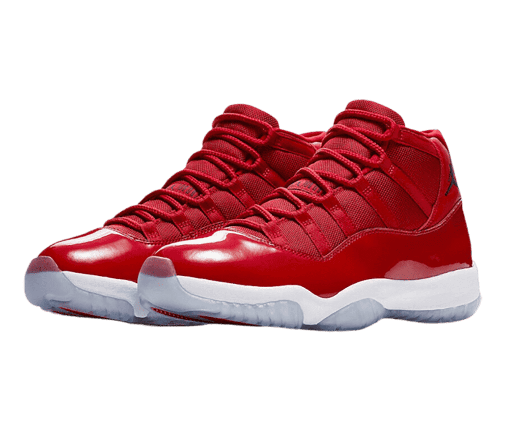 A red pair of AJ11 sneakers with patent leather overlays, white midsoles, and translucent outsoles.