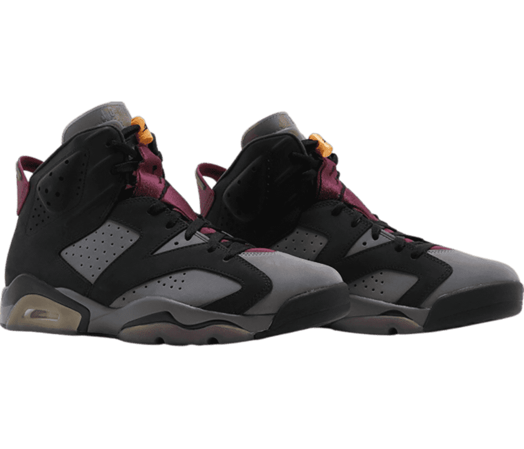 A gray suede pair of AJ6 sneakers with black overlays, purple tongues, and orange lace locks.