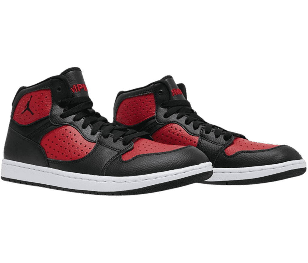A pair of Jordan Access “Bred” sneakers in red perforated uppers with black overlays and laces.