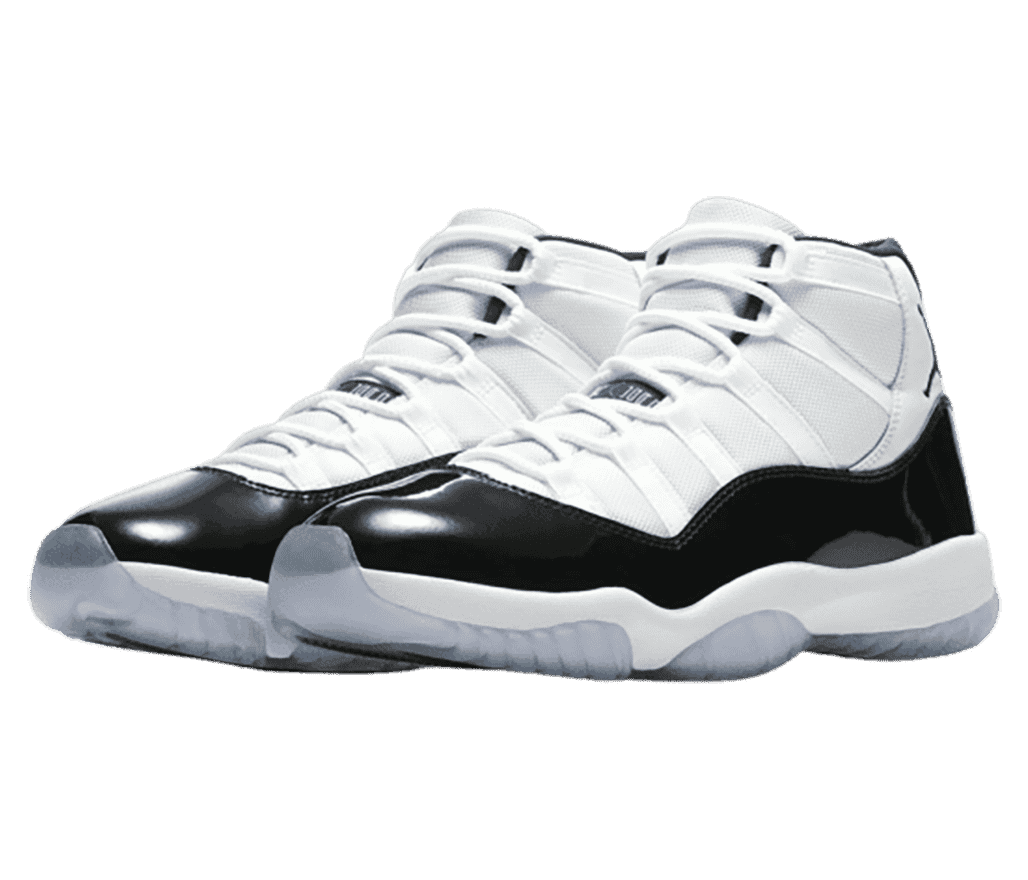 A white pair of AJ11 sneakers with black patent leather mudguards and translucent outsoles.