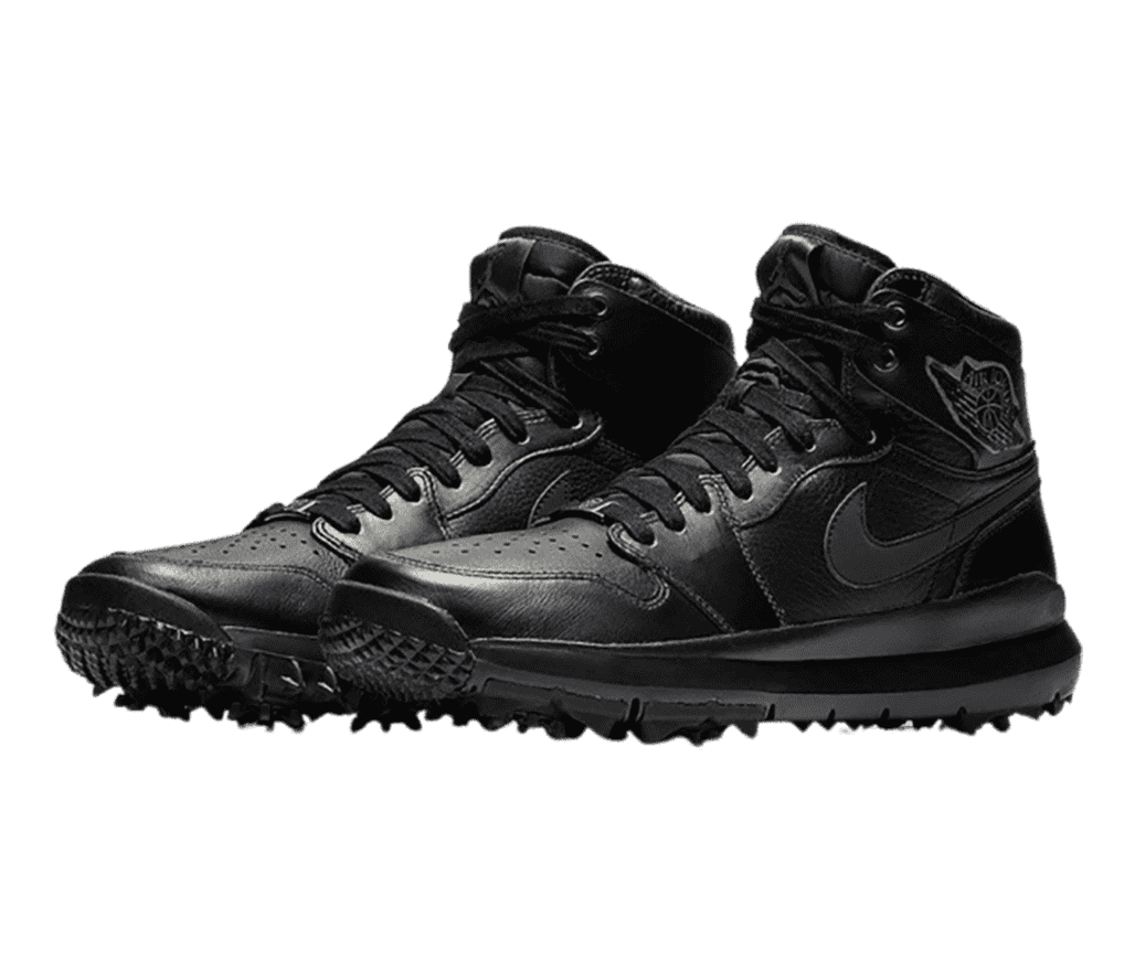 A pair of Nike Jordan golf shoes all in black with spiked soles, and detailed stitching for the shoe pattern and logo.