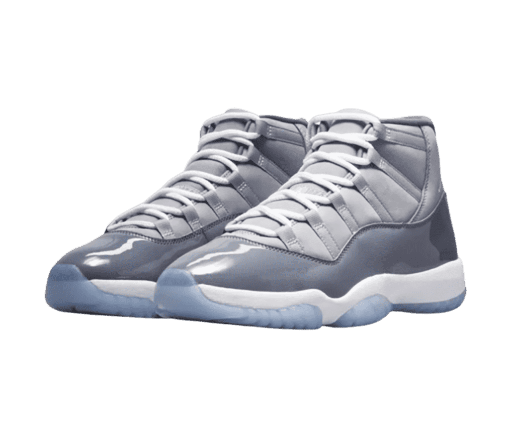 A two-toned gray pair of AJ11 sneakers with patent leather overlays and light blue translucent outsoles.