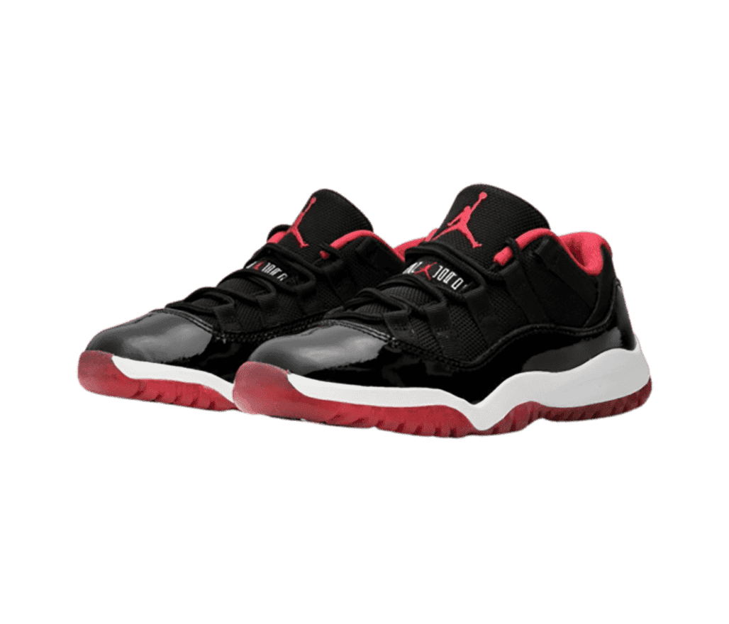 A black pair of AJ11 Low sneakers with white midsoles and red outsoles, logos, and lining.