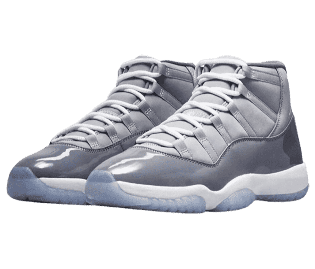 A gray pair of AJ11 sneakers with patent leather overlays, white midsoles, and light blue translucent outsoles.