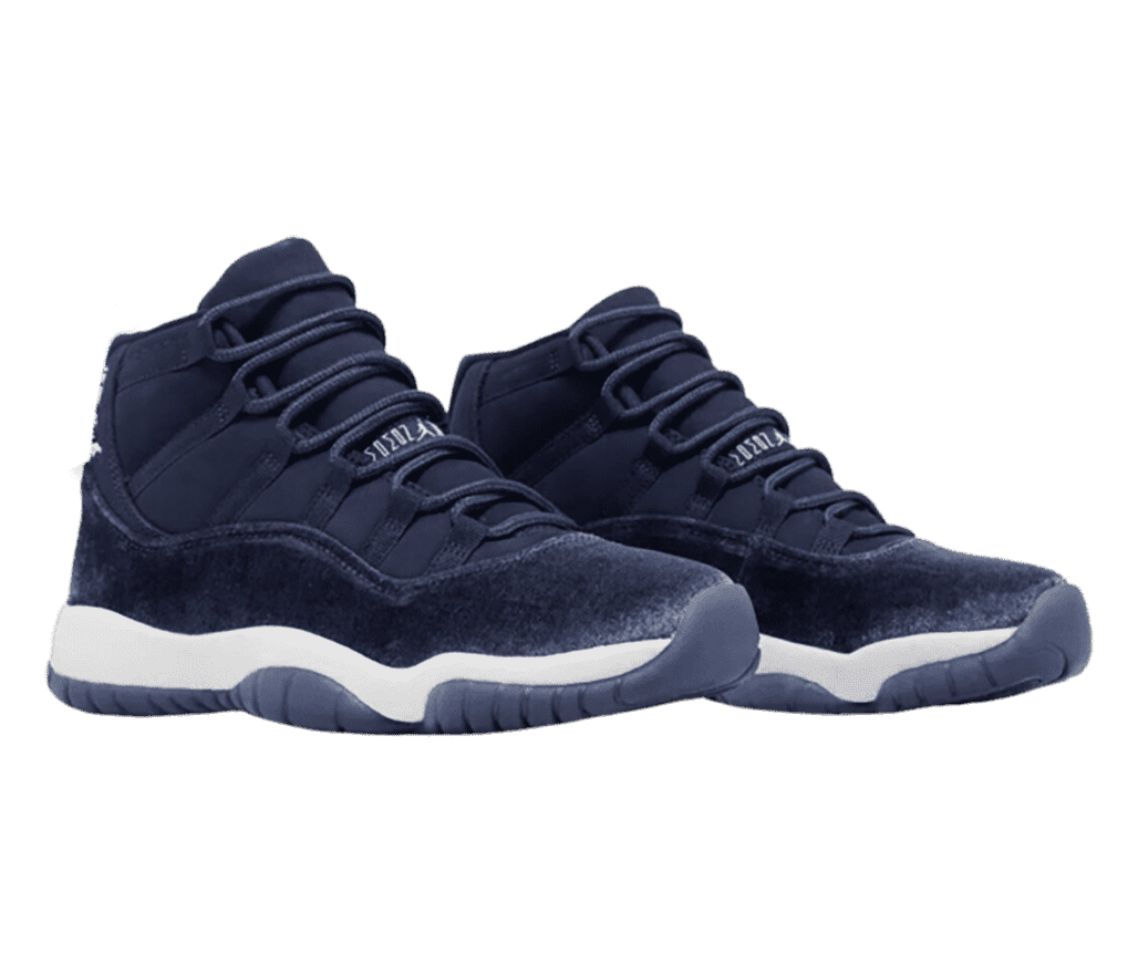 A navy pair of AJ11 sneakers with suede overlays and white midsoles.