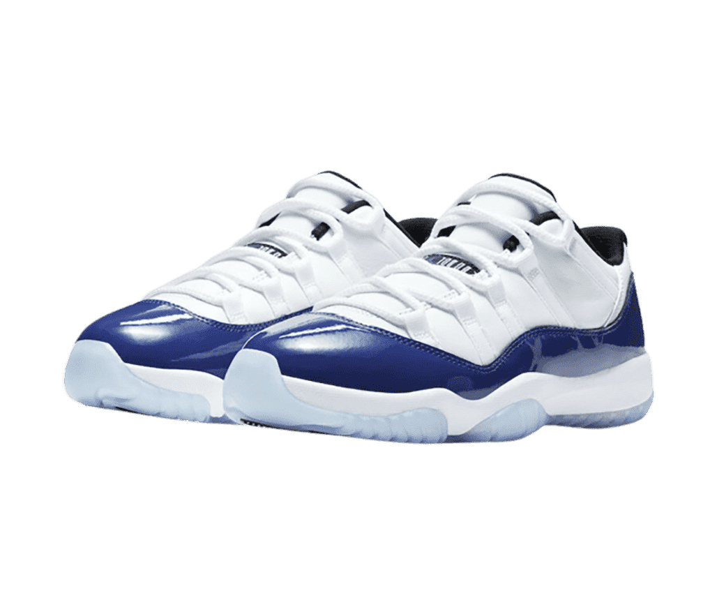 A white pair of AJ11 Low sneakers with blue patent leather overlays and light blue semi-translucent outsoles.
