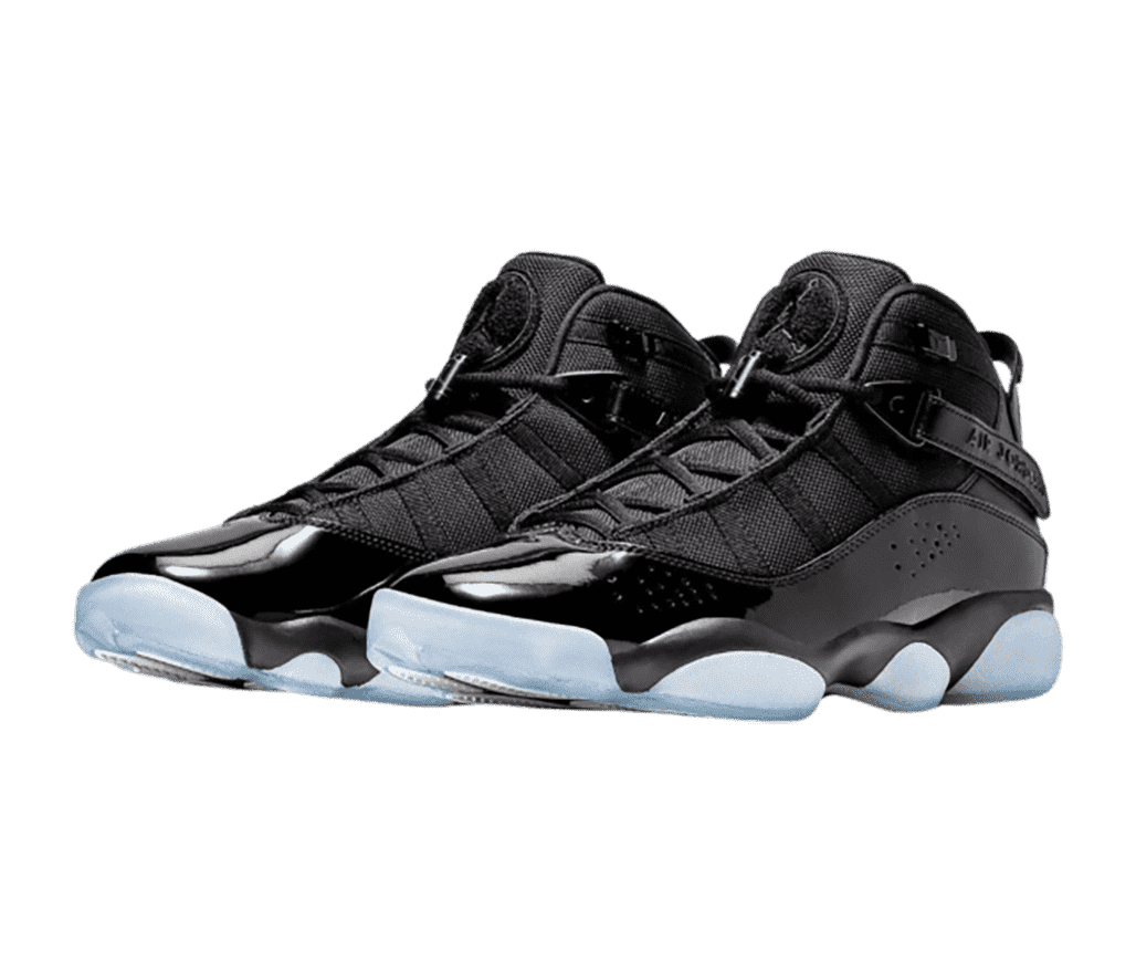 A black pair of Jordan 6 Rings sneakers with patent leather mudguards and light blue translucent outsoles.