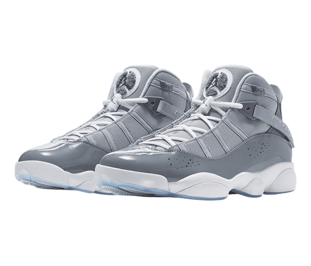 A gray pair of Jordan 6 Rings sneakers with patent leather mudguards, white midsoles, and light blue translucent outsoles.
