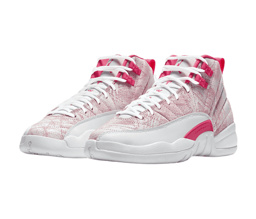 A pair of AJ12 “Arctic Pink” sneakers in a pink cracked paint finish, white mudguards and soles, and hot pink accents.