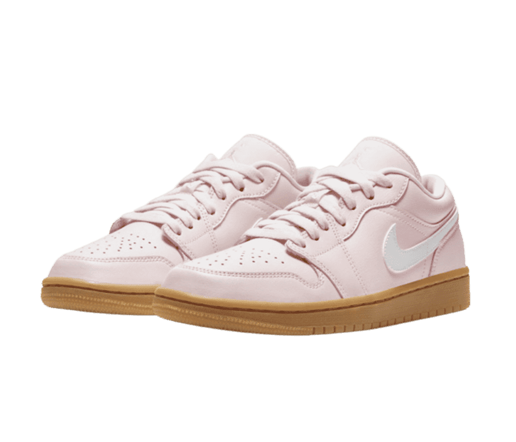 A light pink pair of AJ1 Low sneakers with gum soles and white Swooshes.