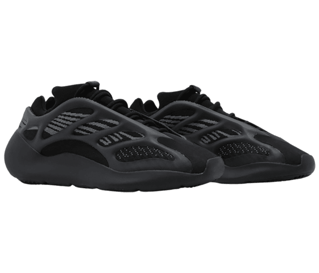 An all-black pair of Yeezy Boost 700 V3 “Alvah” sneakers with mesh uppers, suede toeboxes, and a rubber cage overlay.
