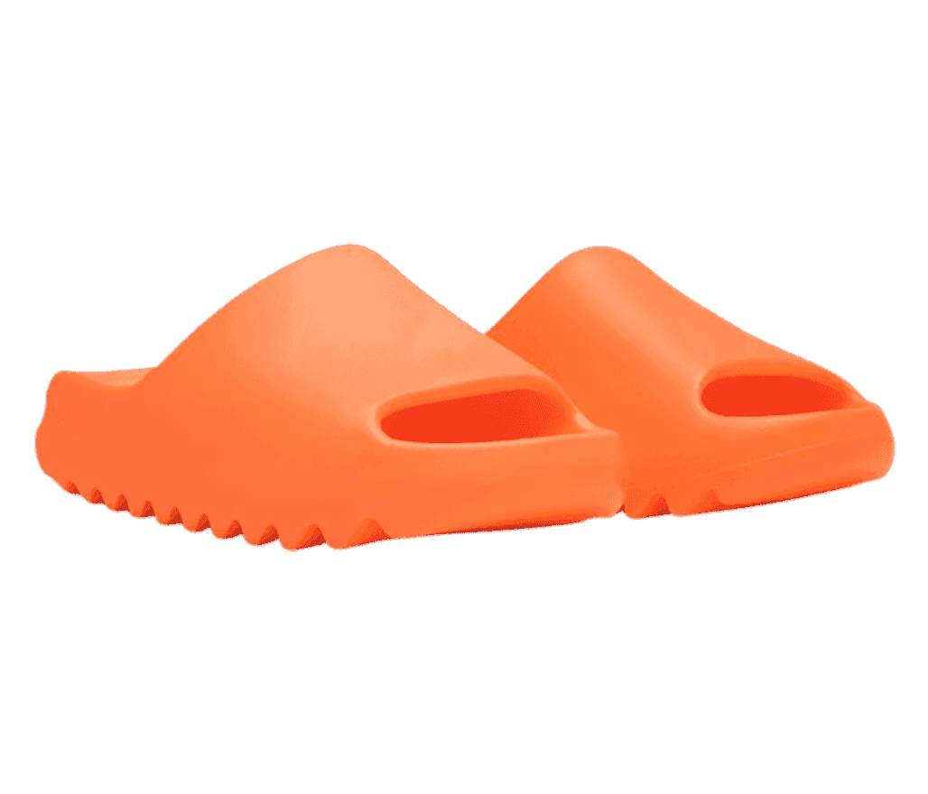 A pair of bright orange Adidas Yeezy “Enflame Orange” slides with zig-zagged soles.