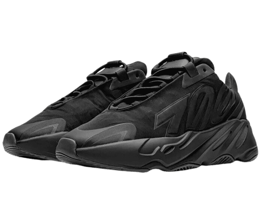 A pair of all-black Yeezy Boost 700 MNVN sneakers with the number “700” written backwards across the lateral sides.