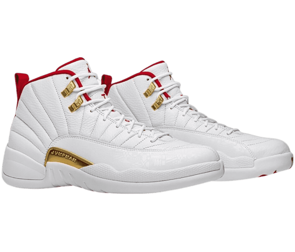A white pair of AJ12 sneakers with gold accents.