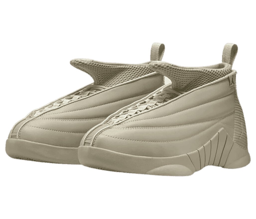 A pair of light beige Billie Eilish x AJ15 sneakers with mesh collars, winged tongues, and striped rubber heels.