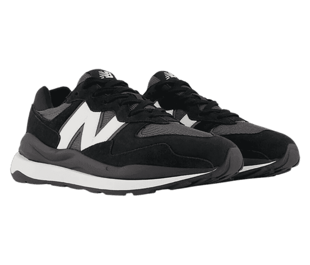 A pair of black New Balance with grey and white accents including the logo, a few spots between the stitiching, and the sole.