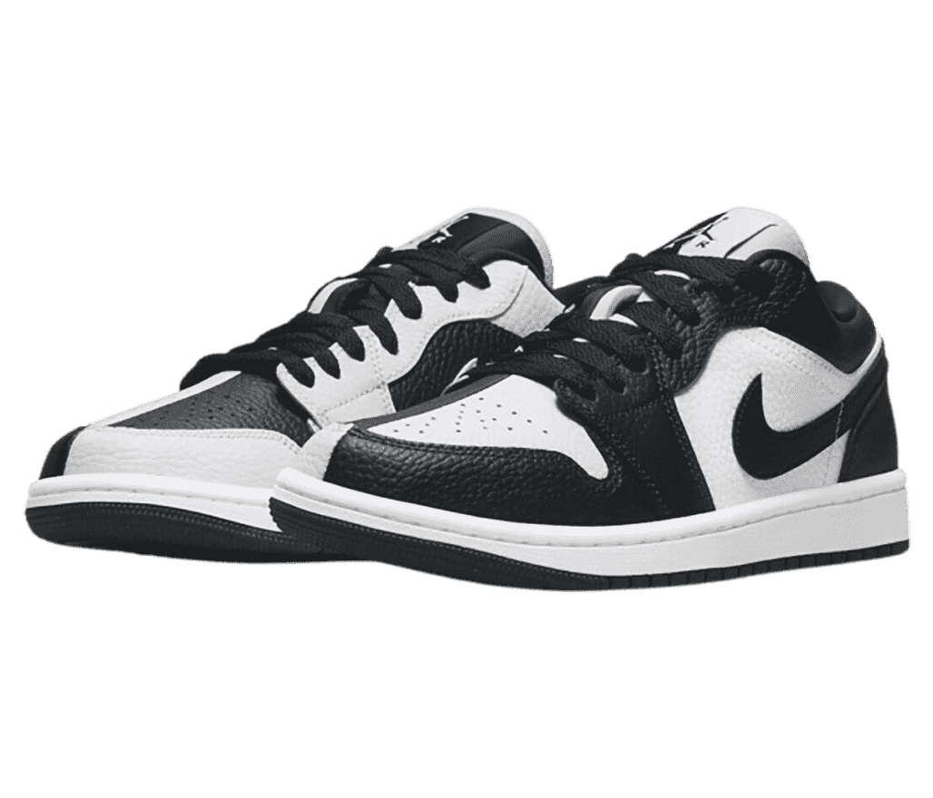 A pair of AJ1 Mid sneakers in black and white with the colors inversed on each half of each shoe.