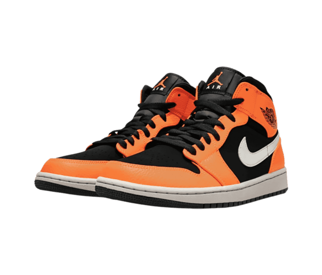 A pair of AJ1 Mid sneakers with black uppers and laces, white Swooshes, and orange overlays.