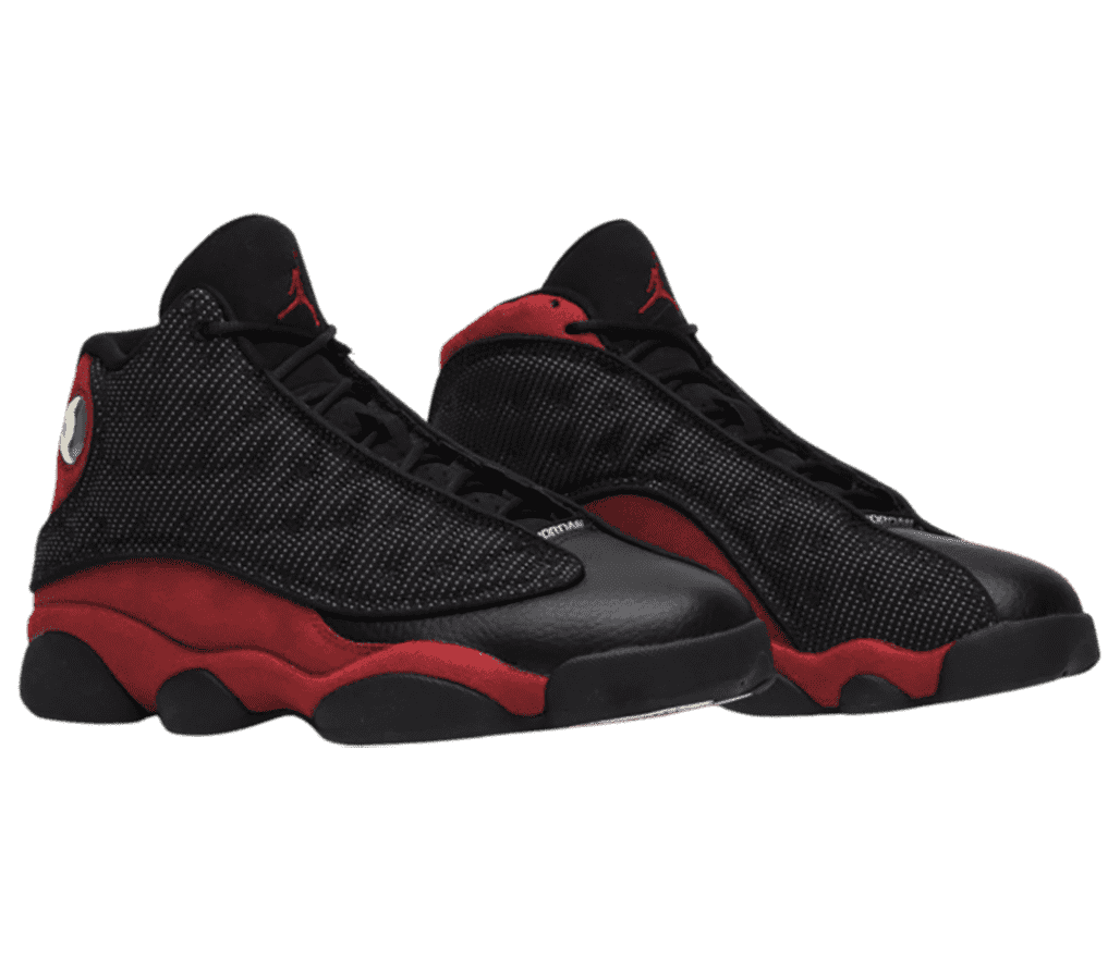 A black pair of AJ13 “Bred” sneakers with white polka-dotted vamps and red quarters and heels.