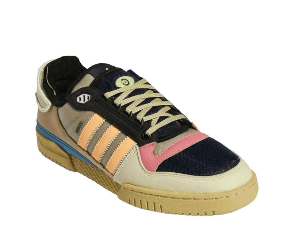 A multicoloured adidas shoe. The shoe is mostly tan, but has pink and black accents on the front, orange vertical stripes on the side, a thin blue stripe above the sole, olive shoe laces, and a black tongue with a green eye on it.