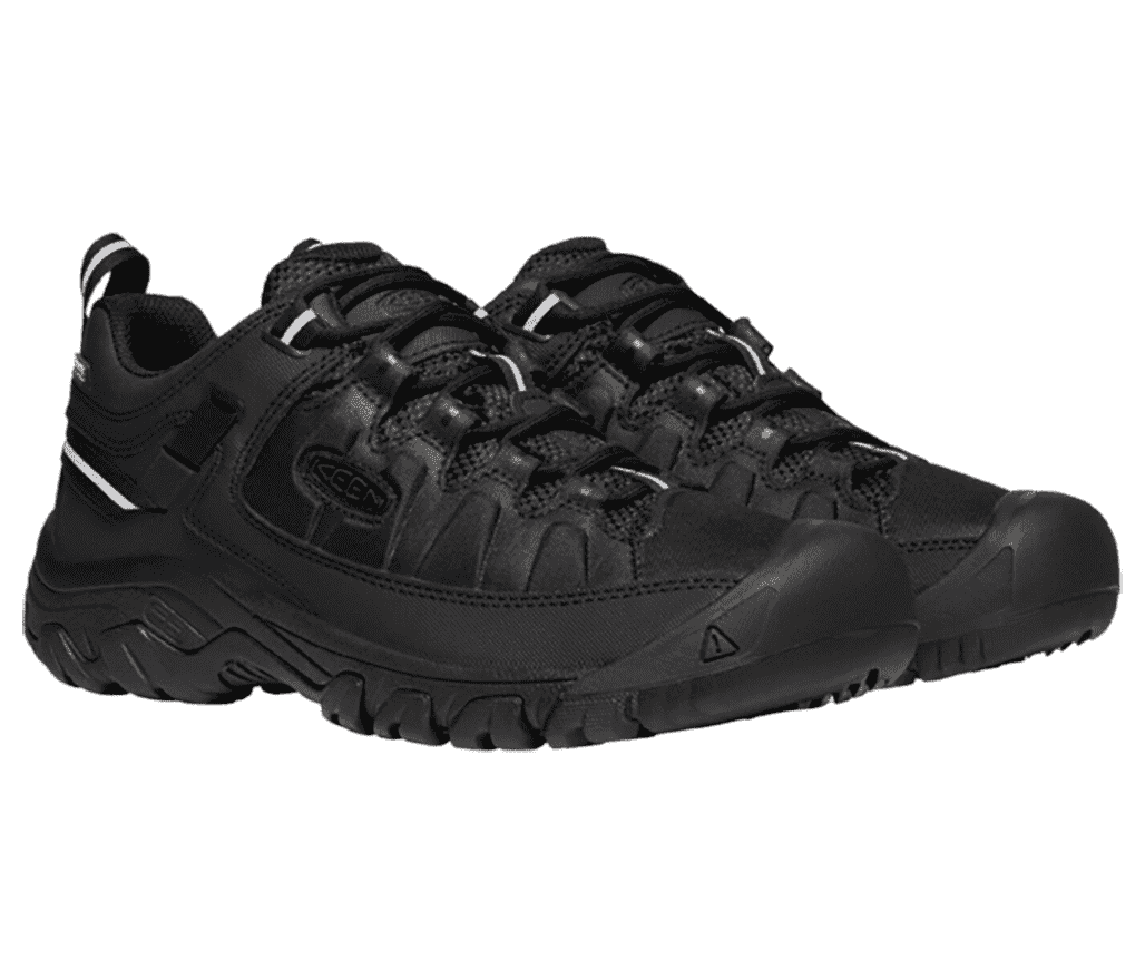 A pair of all-black Keen Targhee shoes with gray logo patches in the midsections of the lateral sides and gray patches with general warning signs—an exclamation point in a triangle—to the right of the toes.