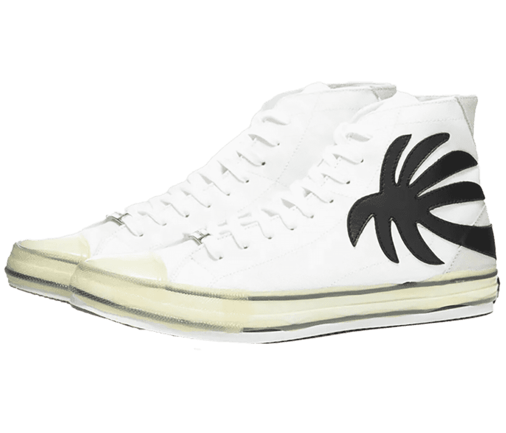 A pair of Palm Angels high-top sneakers in white with their black signature palm tree patch at the heel-end of the lateral side. The midsole and toebox are covered in a yellowish tint with two black lines running around the entire sole.