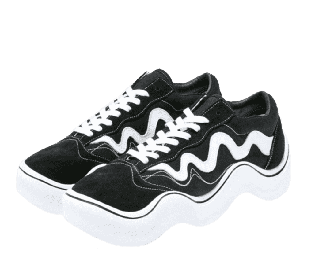 A pair of black Wavy Baby Sneakers. The shoe resembles a black Vans Old Skool shoe, but everything from the white logo on the side to the sole is distorted to look like a Sine wave.