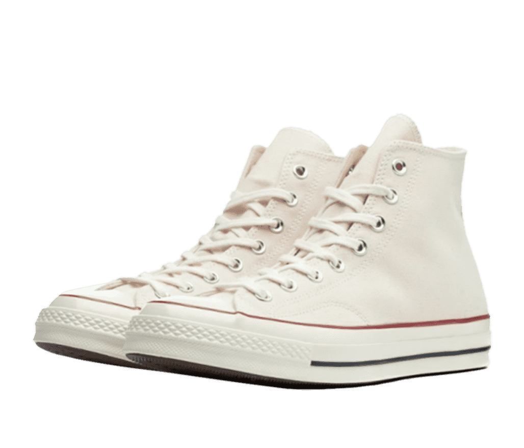 A pair of white Converse Chuck Taylor shoes. Just above the sole is a thin red stripe the stretches across the shoe. The sole has a thin black stripe that stretches across the back half of the shoe.