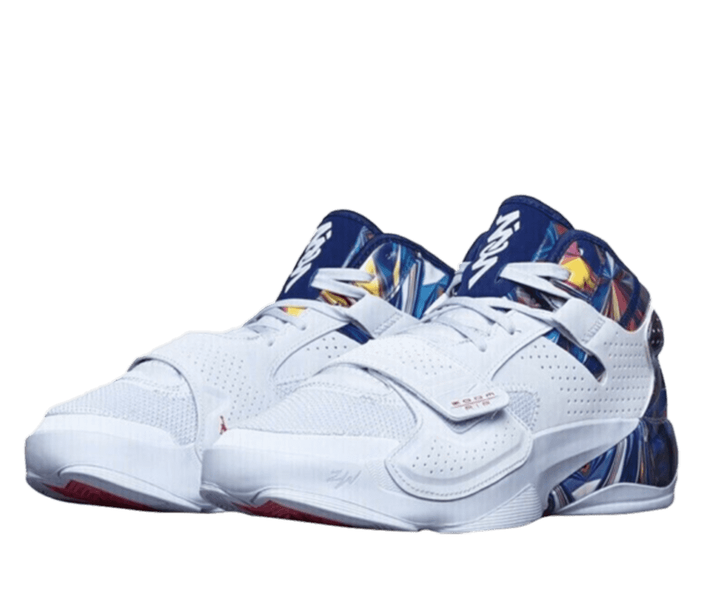 Front left-angled view of a pair of Jordan Zion 2s. The front and tops are white leather with an adjustable strap. The tongue is navy blue and has the Zion symbol down the front in white. The back of the shoe around the heel is a multicolored pattern of mainly blue with some red, purple, yellow, and orange.