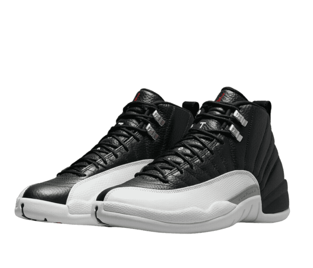 A pair of black and white Air Jordan 12s. The shoe is primarily black leather with a white panel running from the side to the toe. The shoe has a red Air Jordan logo on the tongue and metallic lace stays.