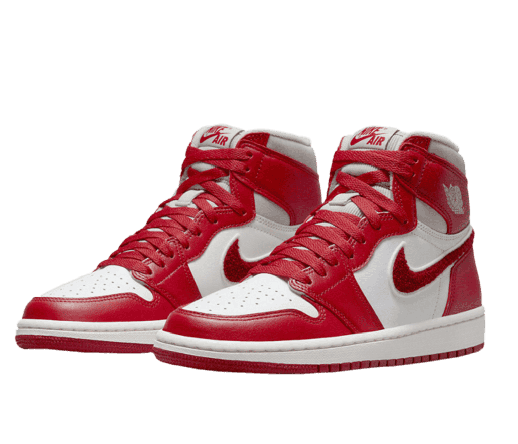 Front left-angled view of a pair of red and white Air Jordan 1s. The top of the toe, tongue, side, and around the top of the heel is white. And features a red overlay on top. The Nike swoosh on the side is made out of a red sherpa fabric.