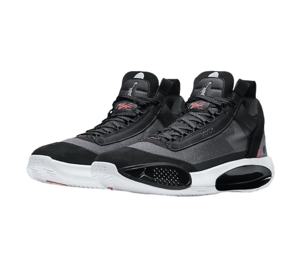 A black pair of AJ34 “Heritage” sneakers with dark gray rubber quarters and white midsoles.