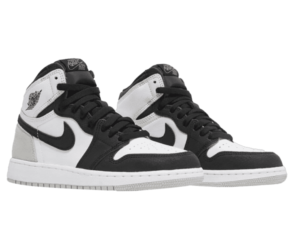 A pair of AJ1 High “Stage Haze” white leather uppers, with black suede tips, and light gray suede heels.