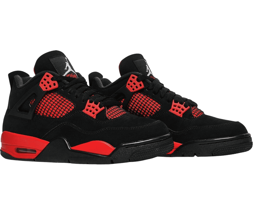 A black pair of AJ4 Retro sneakers in suede, black netted sections on top of red on the sides and lower tongue, red lace cages and midsoles, and black outsoles.